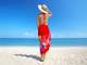 lady standing with her back to the audience looking at the beach in front of her